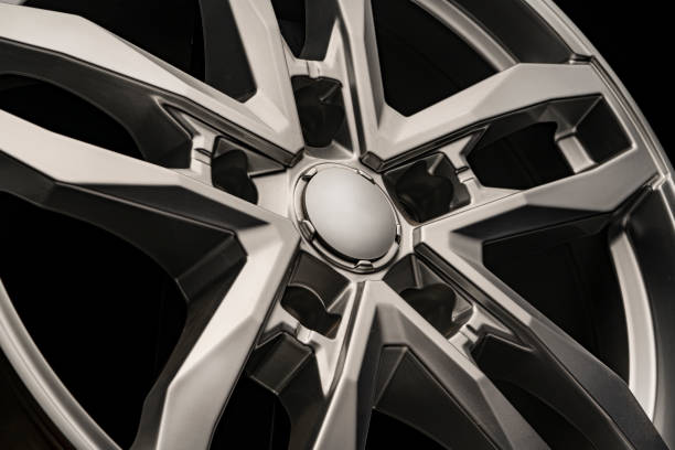 istock silver SUV Allloy wheel, close-up on a black background 1256821126