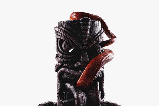 istock Corn snake with tiki totem isolated on white background 1256822455