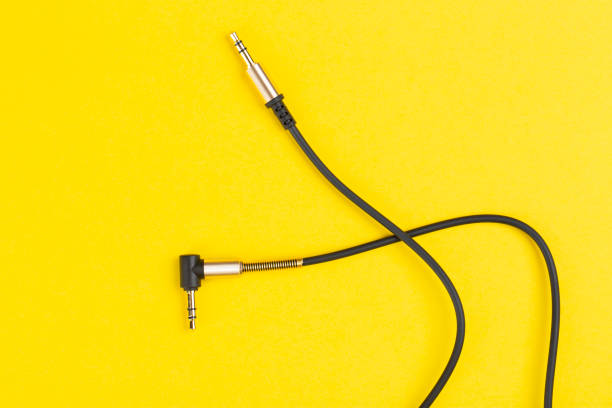 Black jack plug on the yellow background. Black jack plug on the yellow background. Top view. amplifier plug stock pictures, royalty-free photos & images