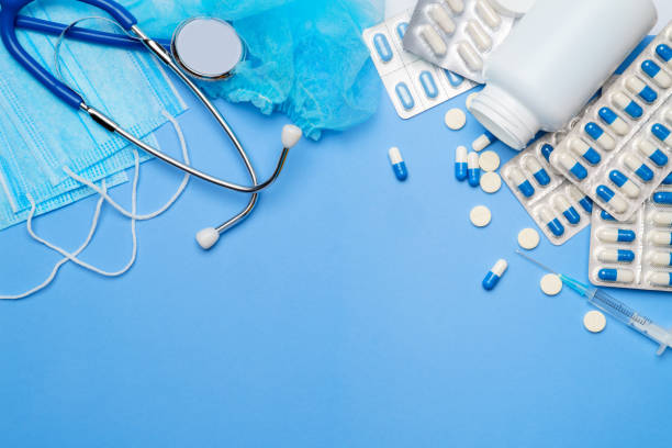 istock Coronavirus protection concept - stethoscope, protective mask, pills, syringe on blue background. 1256826675