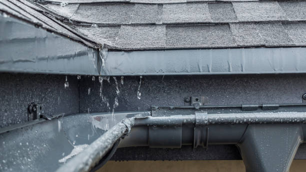 Jets of rain drain into the drainage system on the roof of the house stock photo