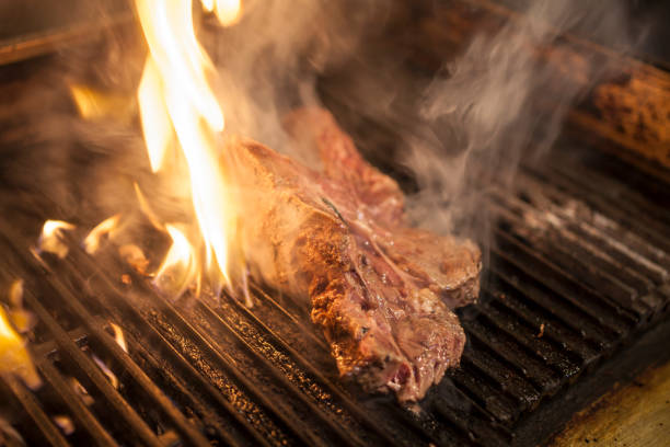istock The piece of steak grilling on the fire 1256834484