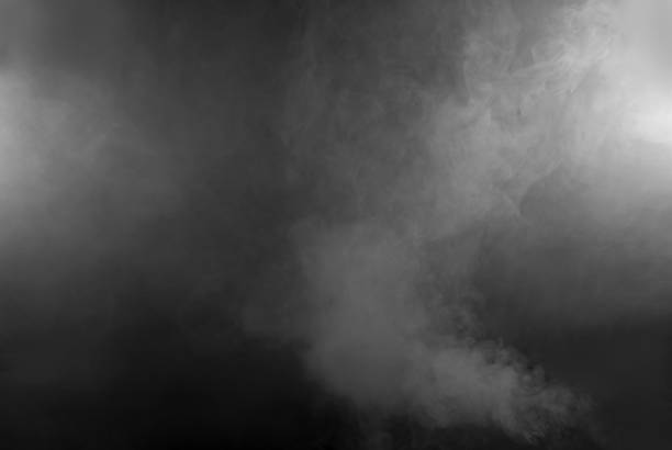 istock White smoke on a black background. The texture of scattered smoke. Blank for design. Layout for collages. 1256835792