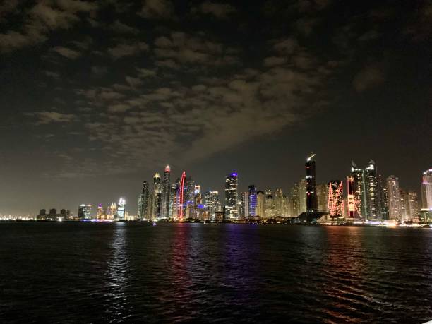 istock Night cityscape from the sea 1256835874