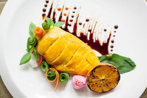 istock Cooked chicken breast designed by vegetables and sauce 1256835966