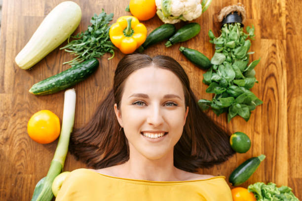 istock A woman lies surrounded with fresh vegetables 1256836146