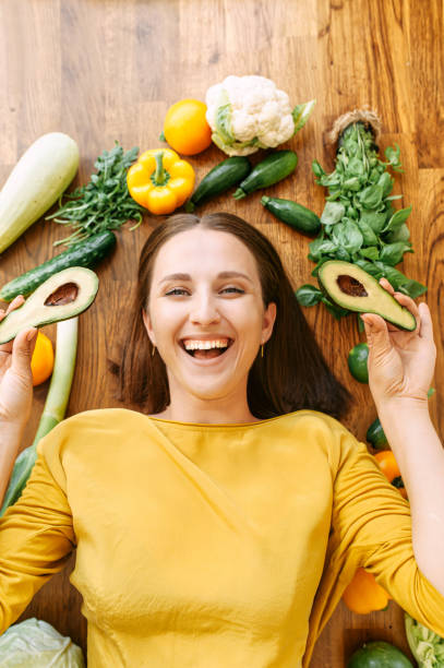 istock A woman lies surrounded with fresh vegetables 1256836148