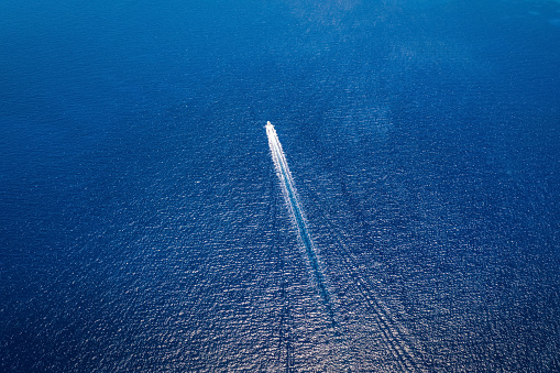 Aerial view of a motorboat travelling over blue, mediterranean sea in Greece , with copy space