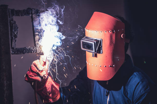 istock Metal welding steel works using electric arc welding machine 1256837301