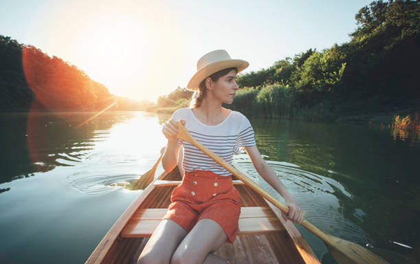 istock Young woman paddling canoe 1256839773