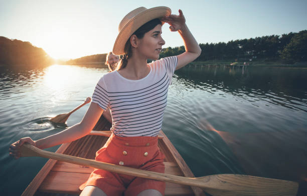 istock Young woman paddling canoe 1256839874