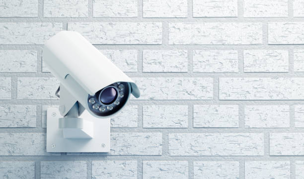 Surveillance Camera on a Brick Wall stock photo
