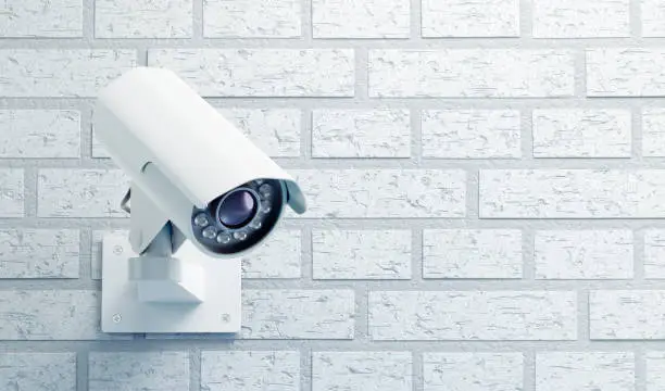 Photo of Surveillance Camera on a Brick Wall