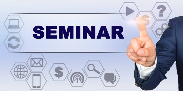 istock Businessman touching virtual screen with his finger. Screen caption - SEMINAR 1256841513