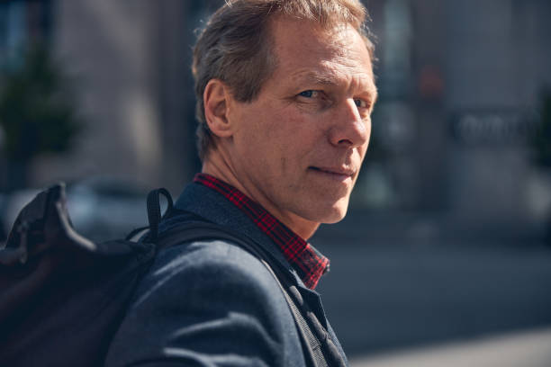 istock Serene middle-aged man standing on the street 1256842878