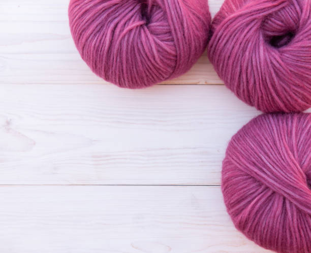 istock Soft purple Yarn on a wooden background. 1256844735