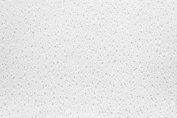 istock Plaster or cast material. Close up of a white background or texture. Irregular surface with grey and black pores. 1256845027