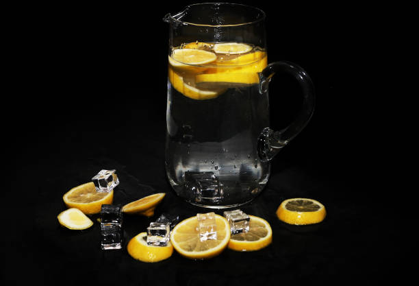 istock wet lemon slices in the water - black background 1256846109