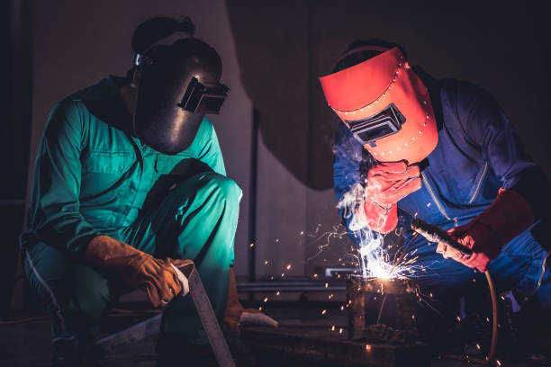istock Metal welding steel works using electric arc welding machine 1256846965