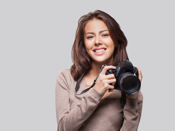istock Young woman photographer with dslr camera 1256847096