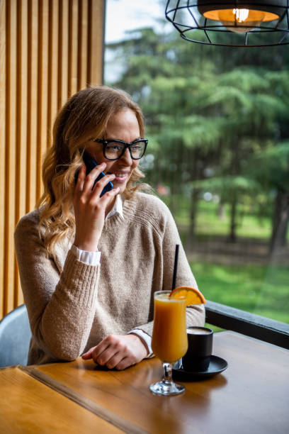 istock attractive female with cute smile having talking conversation with mobile phone. 1256848194