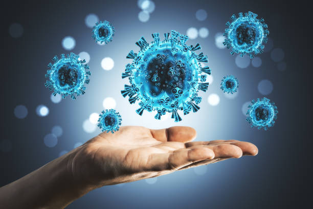 istock Hand holding close-up of virus cells coronavirus 1256851271