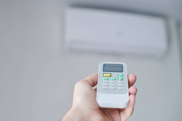 istock Remote control for air conditioner in hand. 1256851395