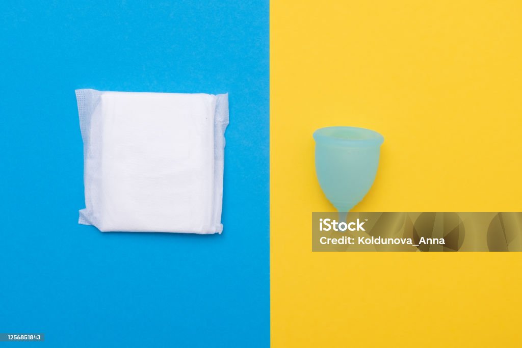 menstruation, cotton tampons, sanitary pads and menstruation cup Woman hygiene protection for menstruation sanitary pads and menstruation cup. Choice between different sanitary options. Top view. Blood Stock Photo