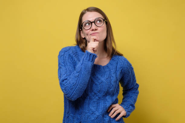 istock Thinking woman in blue sweater pondering over something important. 1256852975