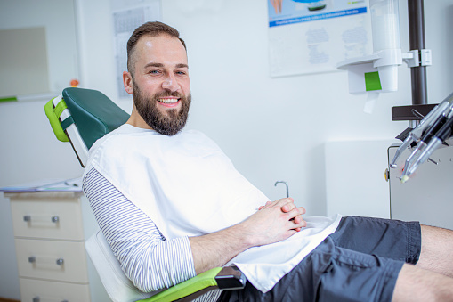 Man sitting in the dental chair and smiling