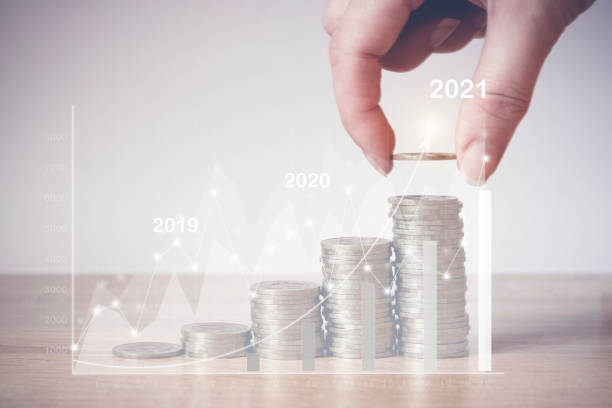 istock 2021.Coins Stack with virtual hologram stat, graph. Concept of money saving, financial. Savings money and income Investment ideas and financial management for the future. 1256853973