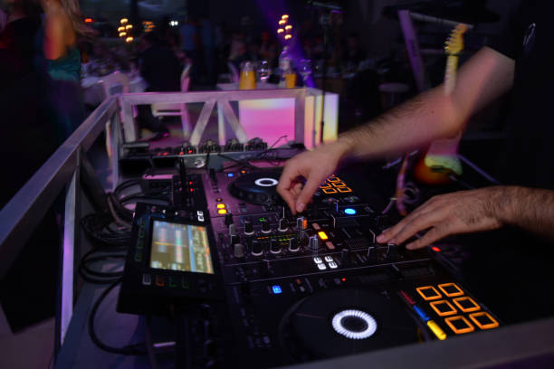 istock DJ with studio mixer in night club 1256854210