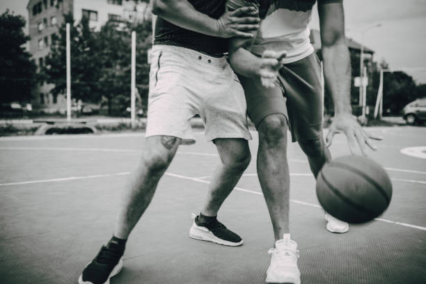 istock Two friends play basketball 1256854211
