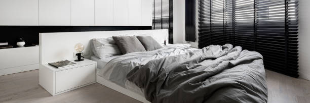 istock White bedroom with big windows, panorama 1256854258