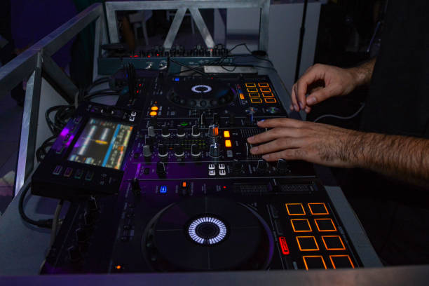 istock DJ with studio mixer in night club 1256854272