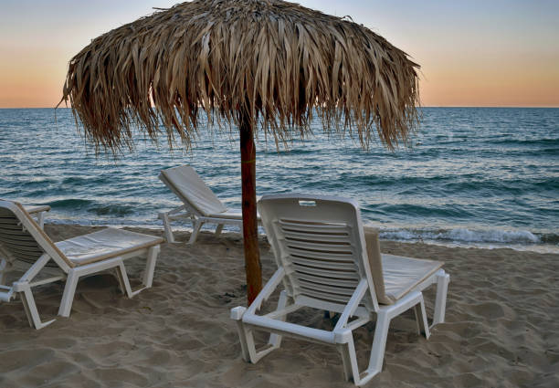 istock Beach Chairs On  Sand Beach At Sunset 1256855429