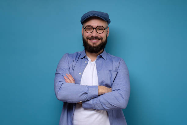 istock Young man with glasses and beard smiling 1256855676