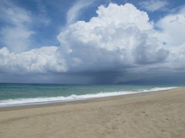 istock Thundercloud over the sea. Beach before a thunderstorm. Rain and sun. 1256858665