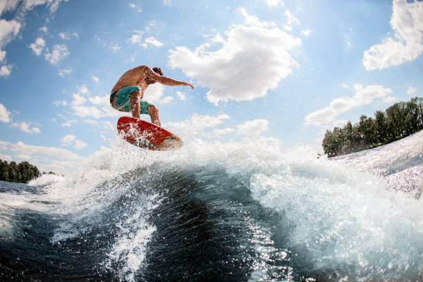 istock Active man jumping on the waves of the river 1256859090