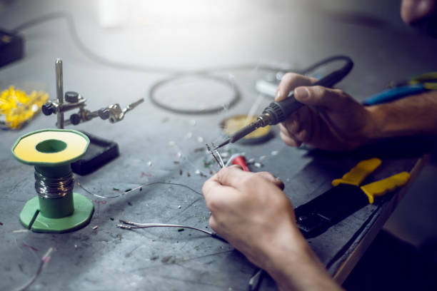 Soldering the wires with soldering iron stock photo