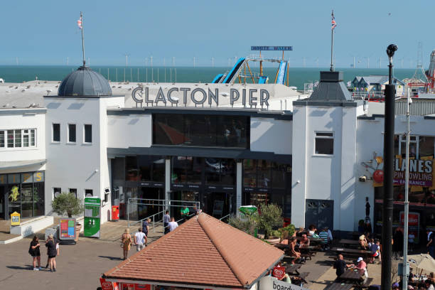 Entrance to Clacton pier with sign. Sunny summers day, Clacton on Sea, Essex Entrance to Clacton's Victorian pleasure pier. With entrance sign. Outdoors on a sunny summers day.  Clacton on Sea, Essex, United Kingdom, July 17 2020 clacton on sea stock pictures, royalty-free photos & images