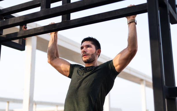 istock Fit man doing pull ups on a bodyweight street workout 1256865239