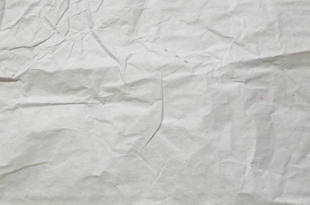 istock Creative background with scattered overlay of crumpled papers. 1256865442