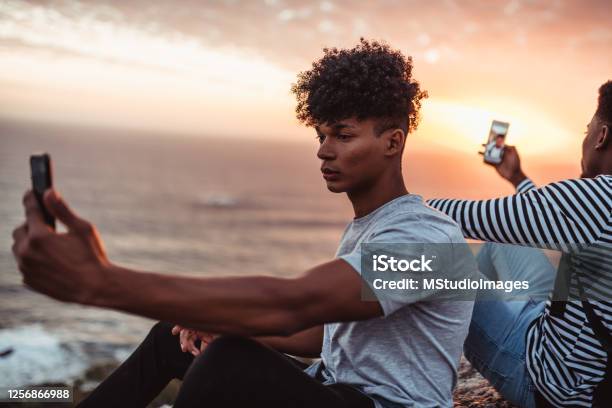Two Young Men Taking Selfies From Different Angles Stock Photo - Download Image Now - Communication, Contented Emotion, Real People