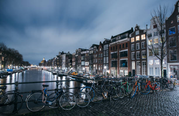 istock Bicycles Along Amsterdam Canal At Night 1256867171