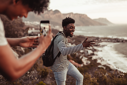 Man taking a photo of his friend while he is dancing
