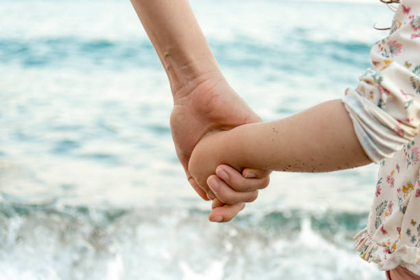 istock Mother holding her daughter's hand 1256869455