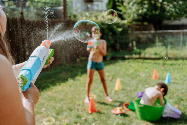 istock Brothers playing with water in the yard 1256871051