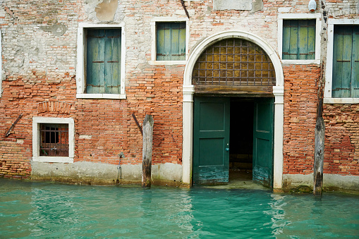 Very old decorated building with boat access from lagoon. Venice. Veneto. Italy.