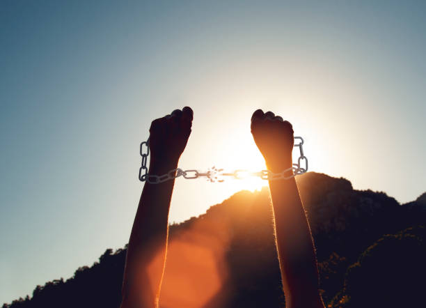 istock A woman breaking chains for freedom 1256873595